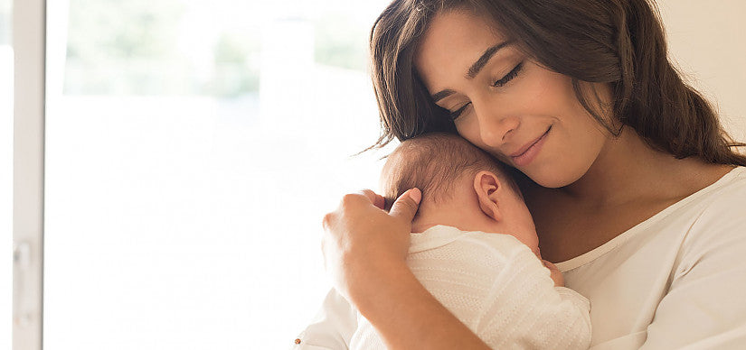 Ouder houdt een baby vast tijdens het voeden